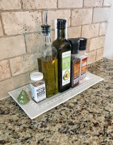 Organize spices and oils on a tray for a farmhouse kitchen element #farmhousedecor #farmhousekitchen #kitchenorganization